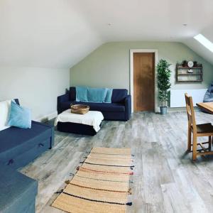 a living room with a couch and a table at Luxury rural retreat near Rutland water in Greetham