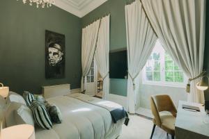 a bedroom with a large bed and a window at Torel Palace Porto in Porto