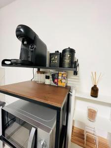 a table with a coffee maker on top of it at Pretty Studio à Bobigny in Bobigny