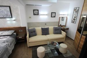 a bedroom with a bed and a couch and a table at Apartment Superior in Fjesa