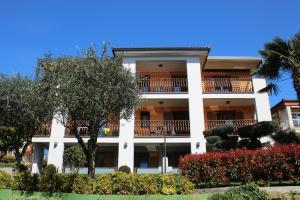 a large white building with trees and bushes at Apartment Superior in Fjesa