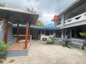 a patio of a house with a wooden deck at Krui Saejadi Surf and Stay in Krui +9 photos