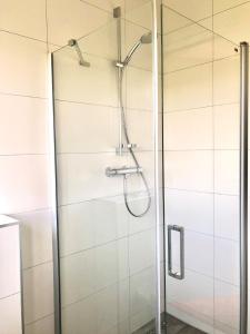 a shower with a glass door in a bathroom at Kustverhuur, Park Scheldeveste Zwin 010 in Breskens +21 photos