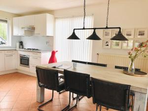 a kitchen with a large wooden table and chairs at Kustverhuur, Park Scheldeveste Zwin 010 in Breskens