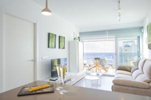 a living room with a couch and a table at Apartamento Natsu - PlusHolidays in Calpe