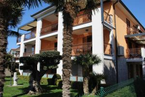 a building with palm trees in front of it at Apartment Silvia in Fjesa