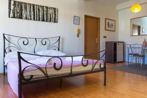 a bedroom with a bed and a dining room at By the sea West Apartments in Kaštela