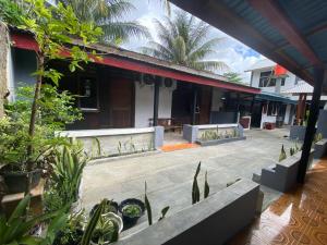 an outdoor patio of a house with plants at Krui Saejadi Surf and Stay in Krui