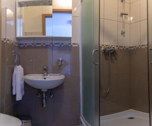 a bathroom with a sink and a shower at By the sea West Apartments in Kaštela