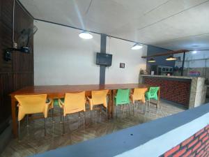 a long wooden table and chairs in a room at Krui Saejadi Surf and Stay in Krui