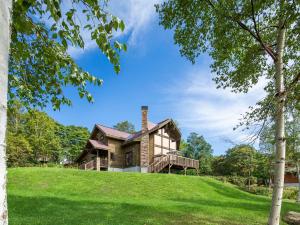 a house on a hill with green grass at Casa La Mount by Elite Havens in Niseko