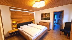 a bedroom with a large white bed in a room at Haus Marienblick in Berchtesgaden