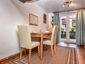 a dining room with a wooden table and chairs at 2 Bed in Ullswater SZ276 in Stainton