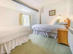 a bedroom with two beds and a window at 2 Bed in Borrowdale SZ302 in Rosthwaite