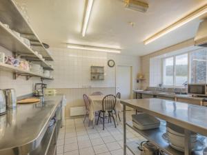 a large kitchen with a table and chairs in it at 8 Bed in Grizedale SZ226 in Grizedale