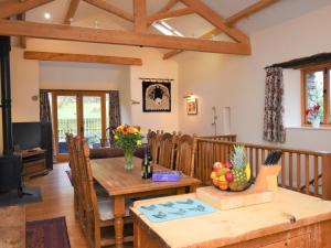 a dining room and living room with a wooden table at 2 Bed in Patterdale SZ470 in Patterdale