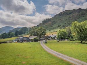 a dirt road in a field with mountains in the background at 2 Bed in Patterdale SZ470 in Patterdale