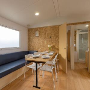 a dining room with a table and chairs at Camping Costa da Morte in Zas