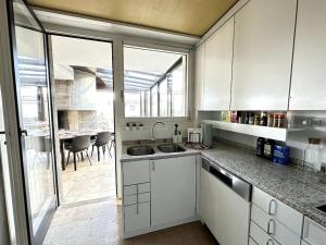 eine Küche mit weißen Schränken und ein Esszimmer in der Unterkunft Pool, Jacuzzi, Games, Nature in Adliswil