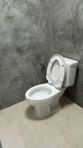 a toilet with the seat up in a bathroom at Eden House Resort in Nakhon Nayok +25 photos
