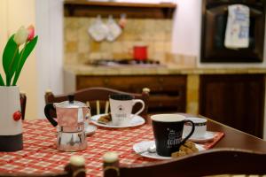een tafel met kopjes en schotels erop bij Suite Laguna in Chioggia
