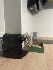 a black printer sitting on top of a kitchen floor at Atypique et central : 4 personnes + Parking privé in Bourges