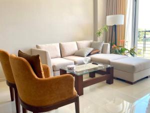 a living room with a couch and a table and chairs at The Breeze- Urban Chic Apartment in Moratuwa