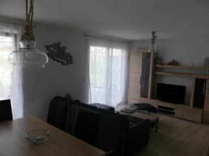 a living room with a table and a couch at FH Moewenkoje_SCHU in Ostseebad Karlshagen