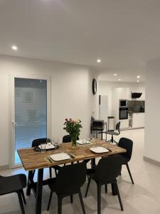 a dining room with a wooden table and chairs at Villa Lancrans in Lancrans