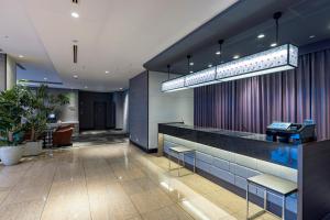 a lobby with a bar with benches and a desk at Tokyu Stay Aoyama Premier in Tokyo