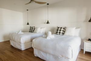 two beds and a couch in a room at Sur Mer Studio - Seaside Escape in Dunsborough
