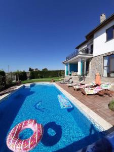 a swimming pool in front of a house at Villa Bellerose in Bozhurets