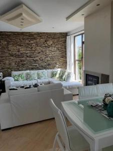 a living room with a couch and a table at Villa Bellerose in Bozhurets