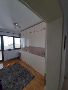 an empty room with white cabinets and a rug at Villa Bellerose in Bozhurets