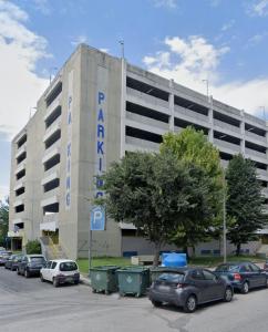 a parking lot with cars parked in front of a building at Work from home Project in Thessaloniki