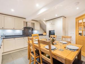 a kitchen with a wooden dining table and chairs at 3 Bed in Dockray SZ247 in Dockray