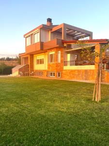 a house with a lawn in front of it at Hillside View Villa in Thermi