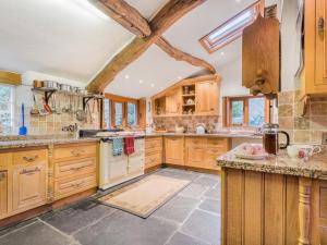 a large kitchen with wooden cabinets and a vaulted ceiling at 5 Bed in Eskdale SZ259 in Eskdale