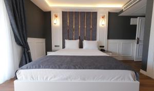 a bedroom with a large white bed with two pillows at Mai İnci Otel in Antalya
