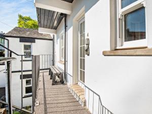 a balcony with a bench on the side of a house at 2 Bed in Keswick SZ027 in Keswick
