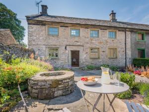 a stone house with a table in front of it at 3 Bed in Shap SZ390 in Shap