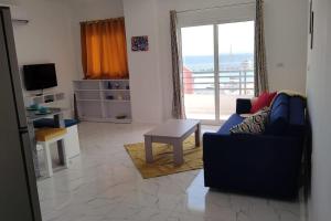 a living room with a couch and a table at Condo with Breathtaking 's view with 2 bedrooms in Hurghada