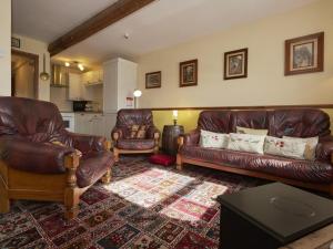 a living room with two leather couches and a table at 2 Bed in Wasdale SZ551 in Nether Wasdale