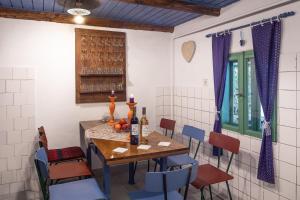 a dining room with a wooden table and chairs at Jelkő Ház Terpes in Terpes