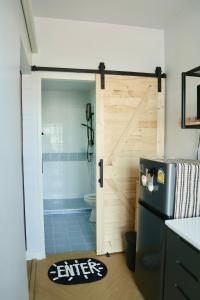 a sliding barn door in a kitchen with a shower at Cozy room in Khlongluang II in Khlong Luang