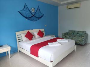 a bedroom with a bed and a blue wall at March Samui Resort in Mae Nam