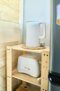 a toaster sitting on top of a wooden shelf at Cozy room in Khlongluang II in Khlong Luang