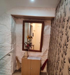 a bathroom with a mirror and a dresser in a room at 2-level apartment in Aberdeen