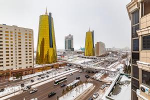 a city with buildings and a street with cars at Апартаменты 2day apart у Байтерека in Astana