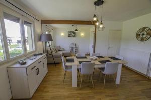 uma cozinha e sala de jantar com mesa e cadeiras em La claire vallee 